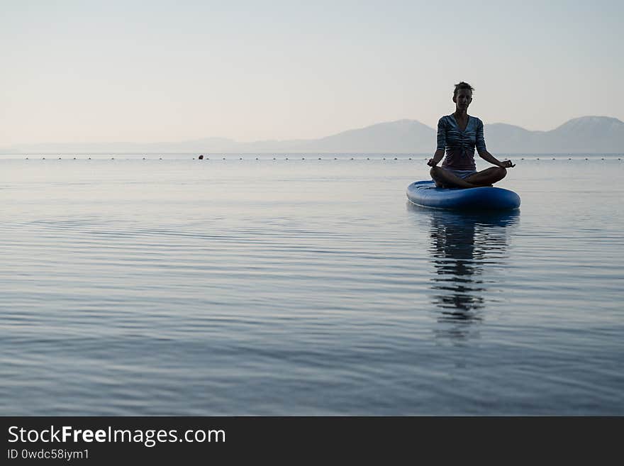 Young woman meditating in lotus position