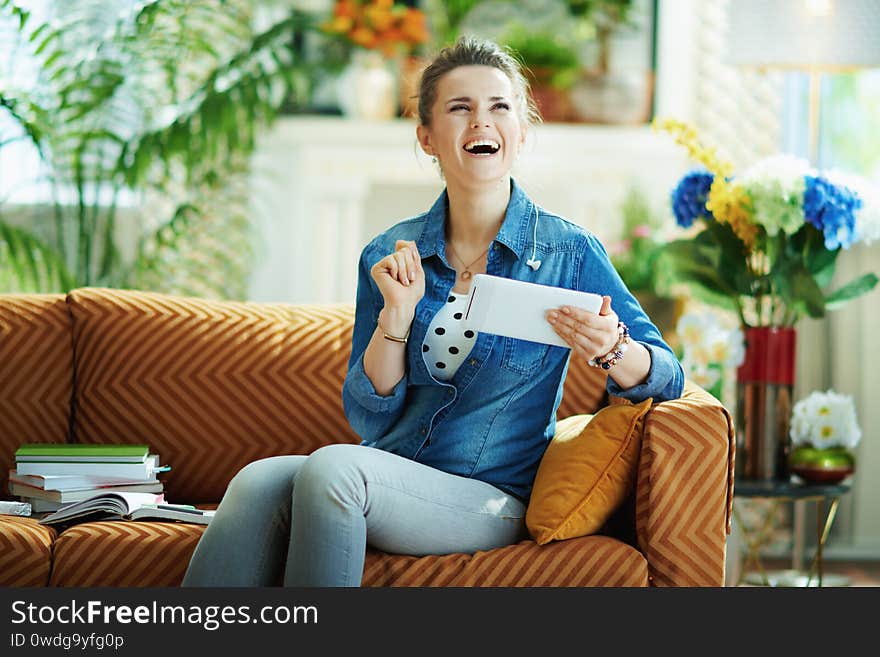 Woman with tablet PC study online at modern home in sunny day