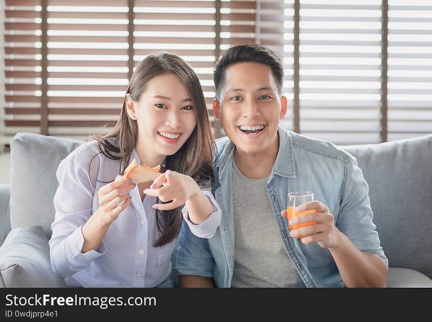 Asian couple lovers enjoy watching entertainment internet streaming via smart television for stay safe at home