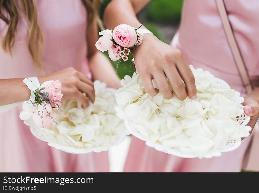 Children hands holding rose petals at the wedding ceremony