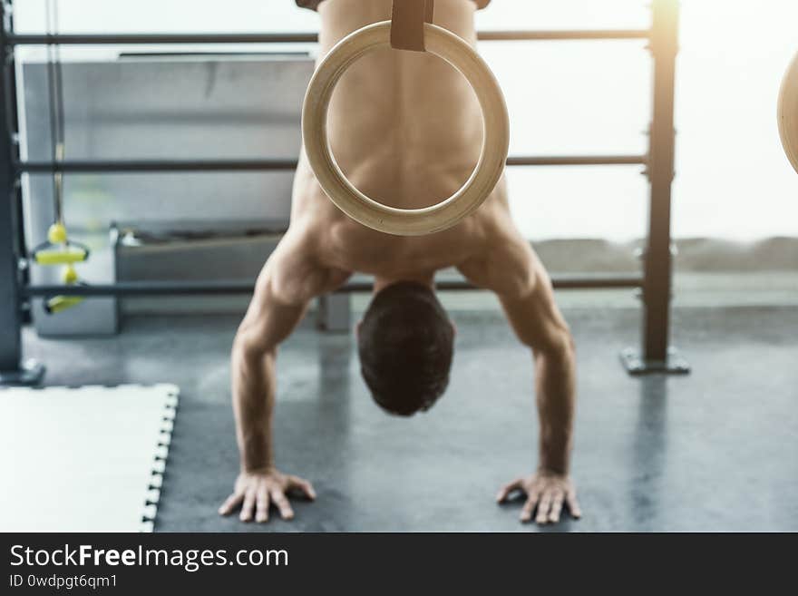 Athletic fit man exercising at the gym and doing a handstand, fitness and balance concept. Athletic fit man exercising at the gym and doing a handstand, fitness and balance concept