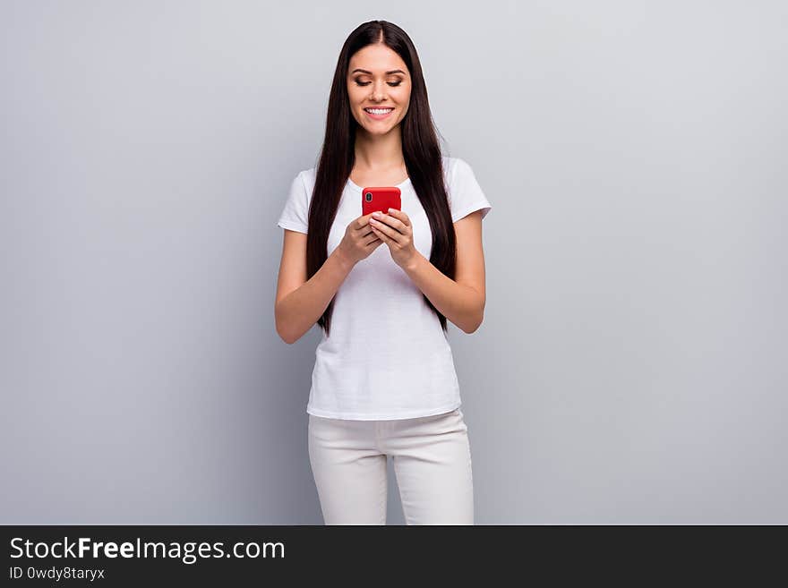 Portrait of her she nice attractive lovely winsome charming cheerful cheery straight-haired girl holding in hands, using cell browsing web isolated over light gray pastel color background. Portrait of her she nice attractive lovely winsome charming cheerful cheery straight-haired girl holding in hands, using cell browsing web isolated over light gray pastel color background