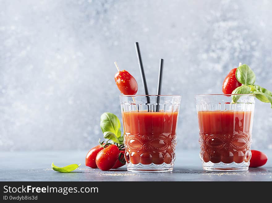 Vegan tomato juice with basil and pepper on the table, selective focus image with a copy space for your text