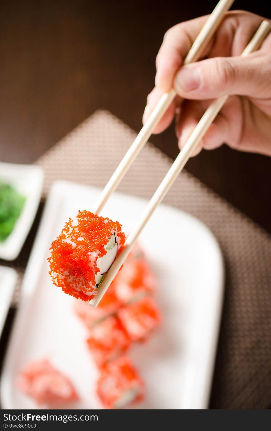 Sushi maki with crab stick, cucumber, philadelphia cheese on a white plate