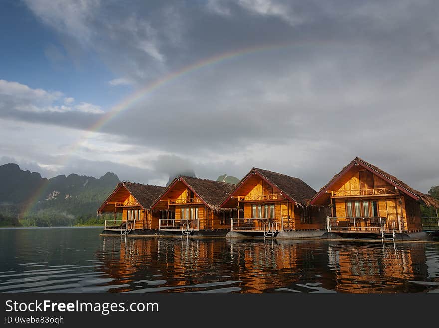 Floating houses at Ratchaprapa dam with rainbow in morning, Surat Thani, Thailand