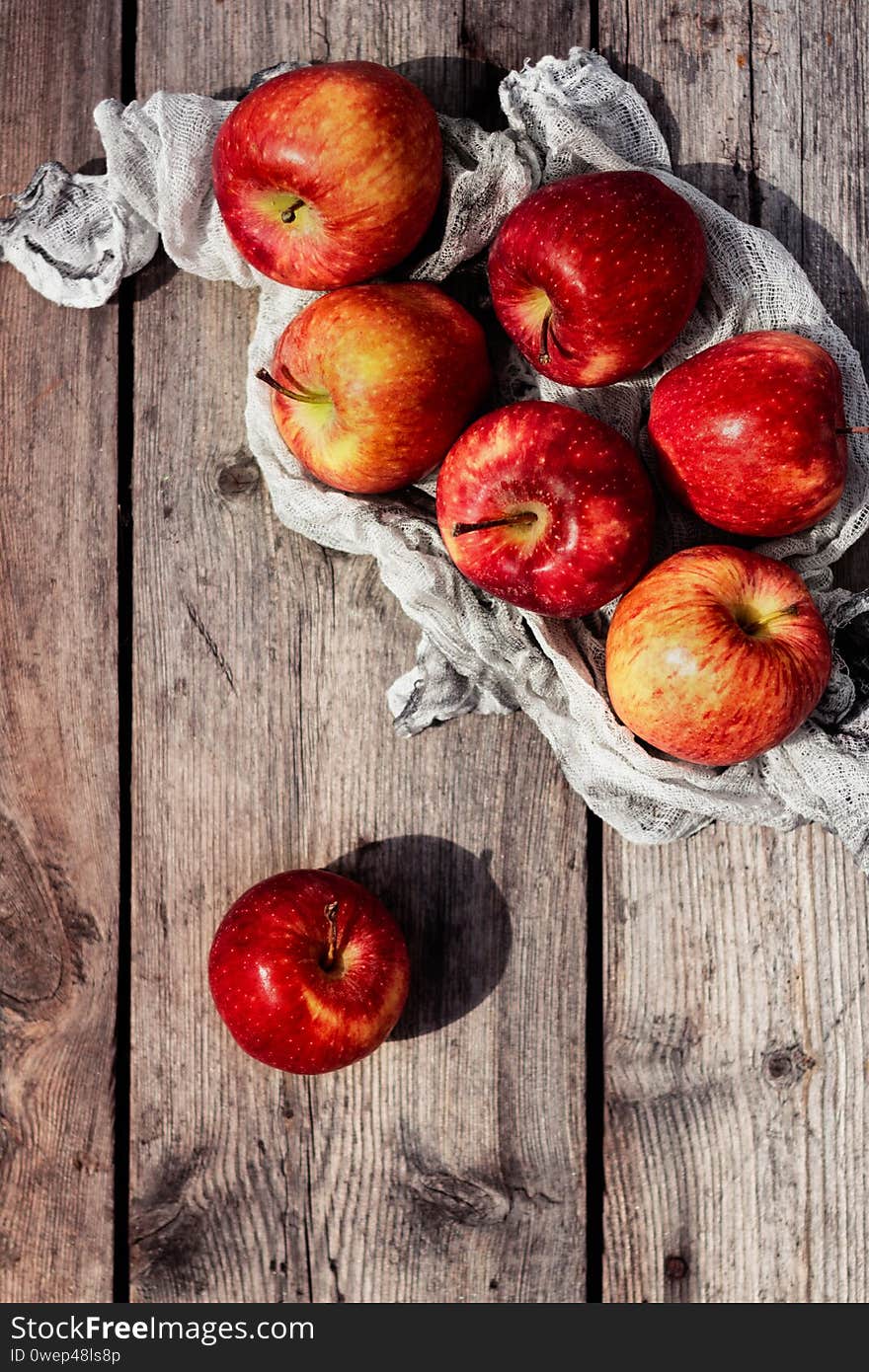 Crop of apples. Juicy summer red,orange, yellow and green apples on a wooden background. Crop of apples. Juicy summer red,orange, yellow and green apples on a wooden background