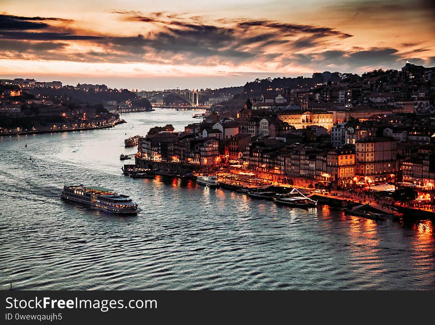 Porto, Portugal, old town cityscape and the Douro River with traditional Rabelo boats, seen from the Dom Luis bridge