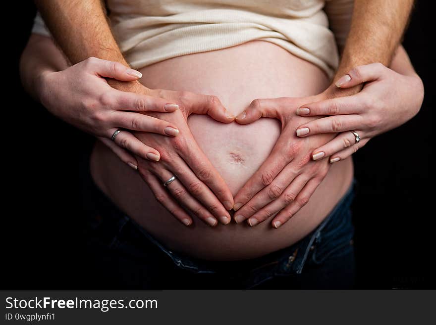 Pregnant couple in love with baby belly. Hands on stomach baby bump. husband hand pregnant belly