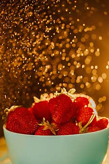 Red Juicy Ripe Strawberries In A Blue Vase On A Black Background. Drops Of Water, Warm Sunshine, Back Light, Vertical Royalty Free Stock Photography