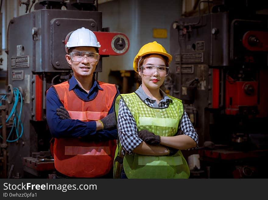 Industry engineer under inspection and checking production process on factory station by document on hand ,Engineer wearing casual uniform and safety helmet in work