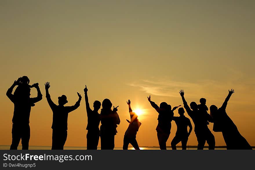 silhouette of a happy family during sunset at the beach