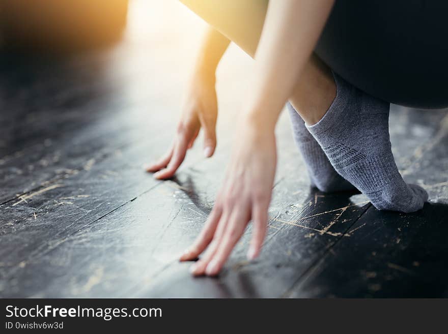 Close up. Chinese girl is engaged in stretching feet. Sports training at home.