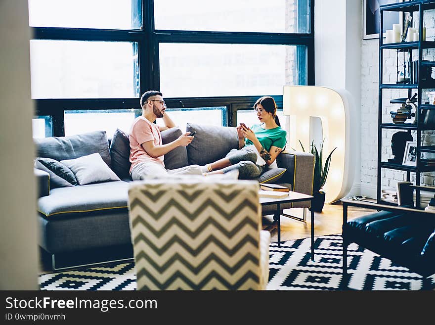 Couple in love resting on cozy couch