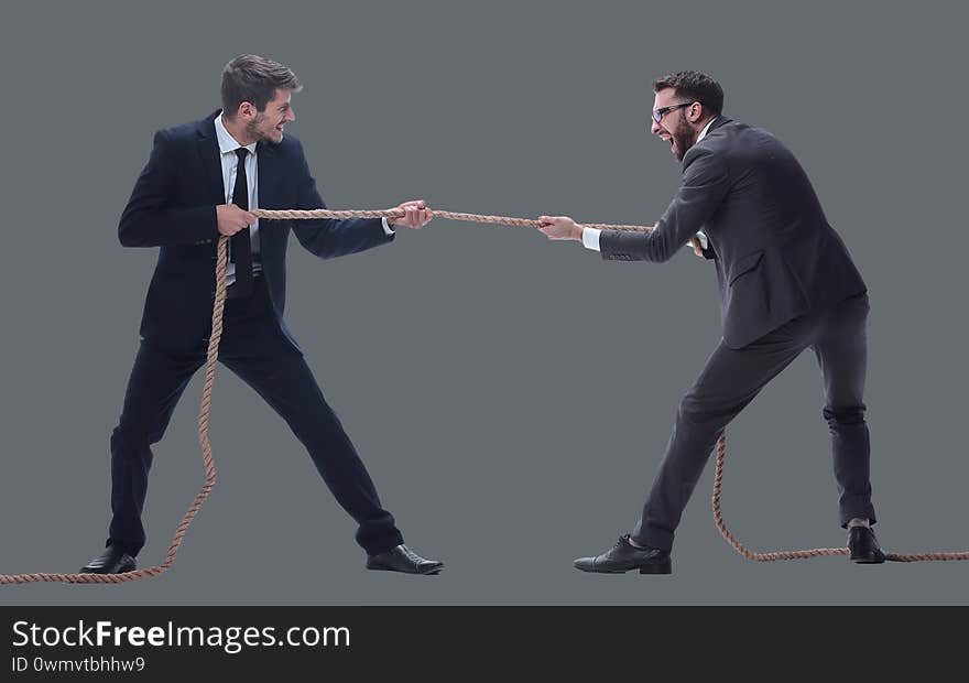 Full length . two smiling businessmen pulling the rope. isolated on white background.