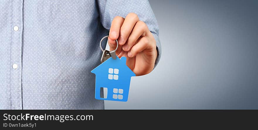 Real estate agent handing over house keys in a hand