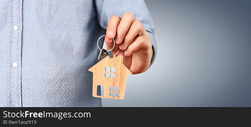 Real estate agent handing over house keys in a hand