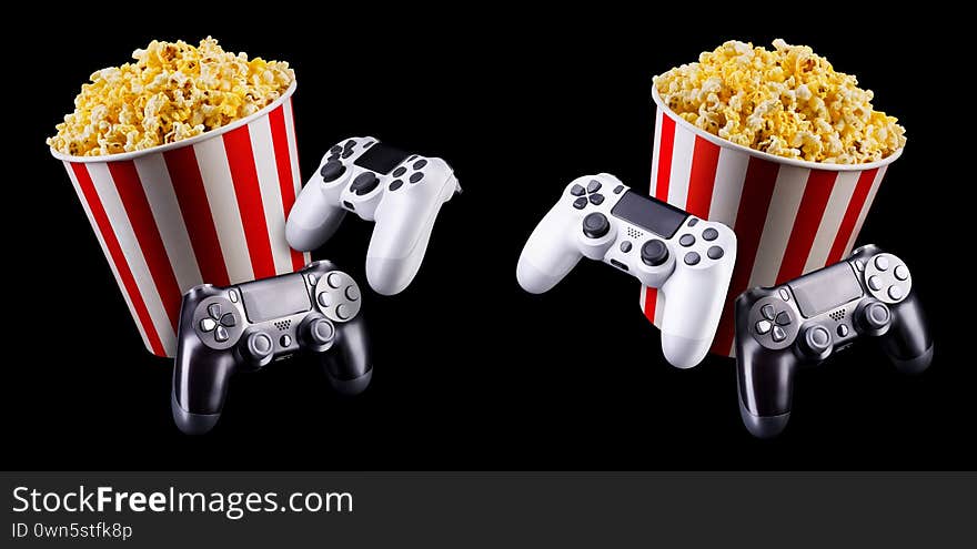 Flying popcorn and video game joystick gamepad isolated on a black background