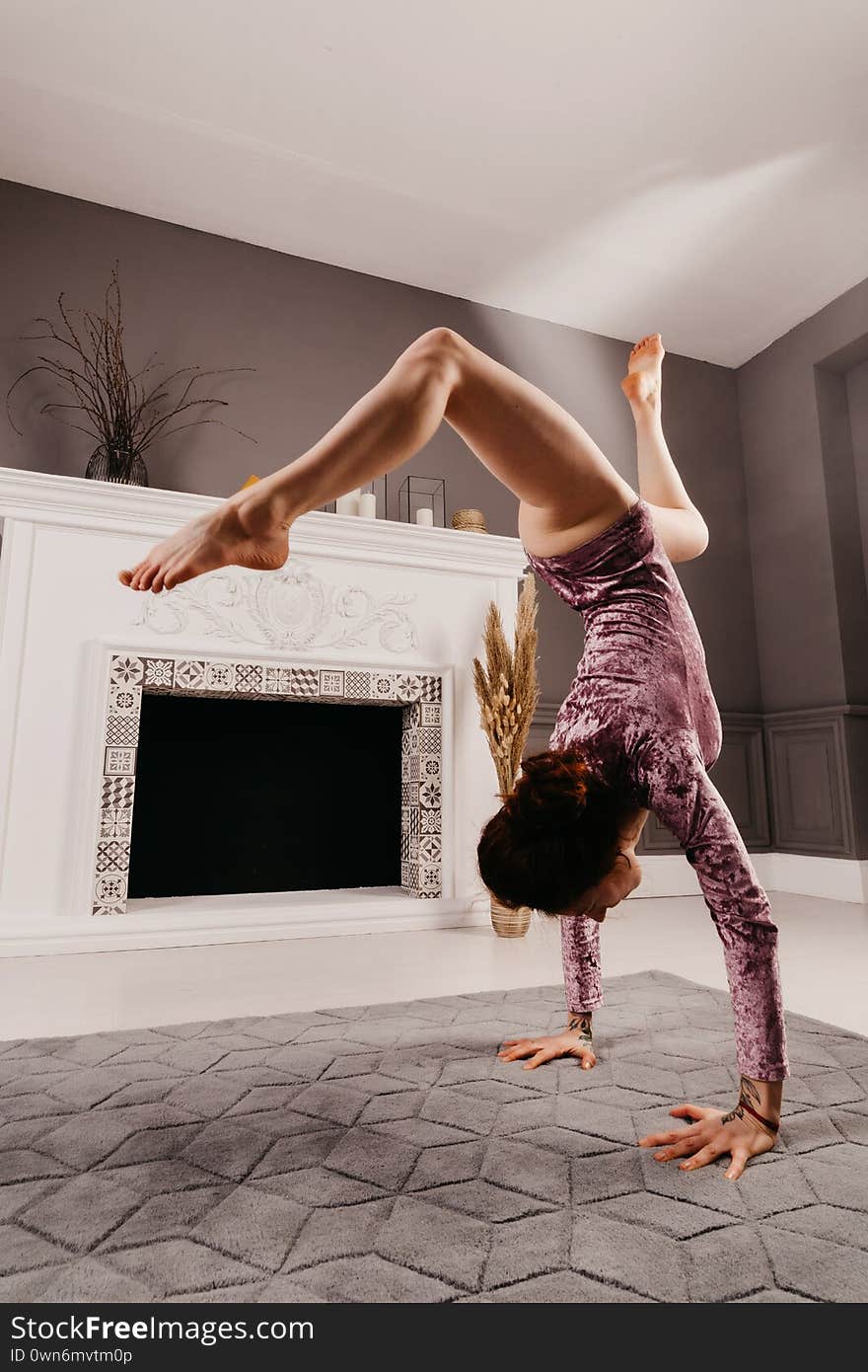 Very Flexible Young Girl Doing Yoga In The Minimalism Room