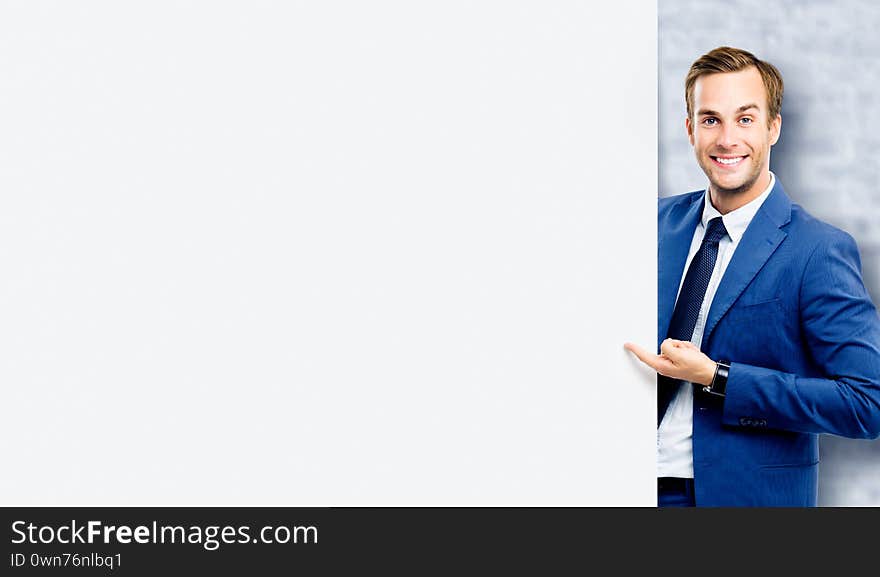 Businessman showing blank signboard