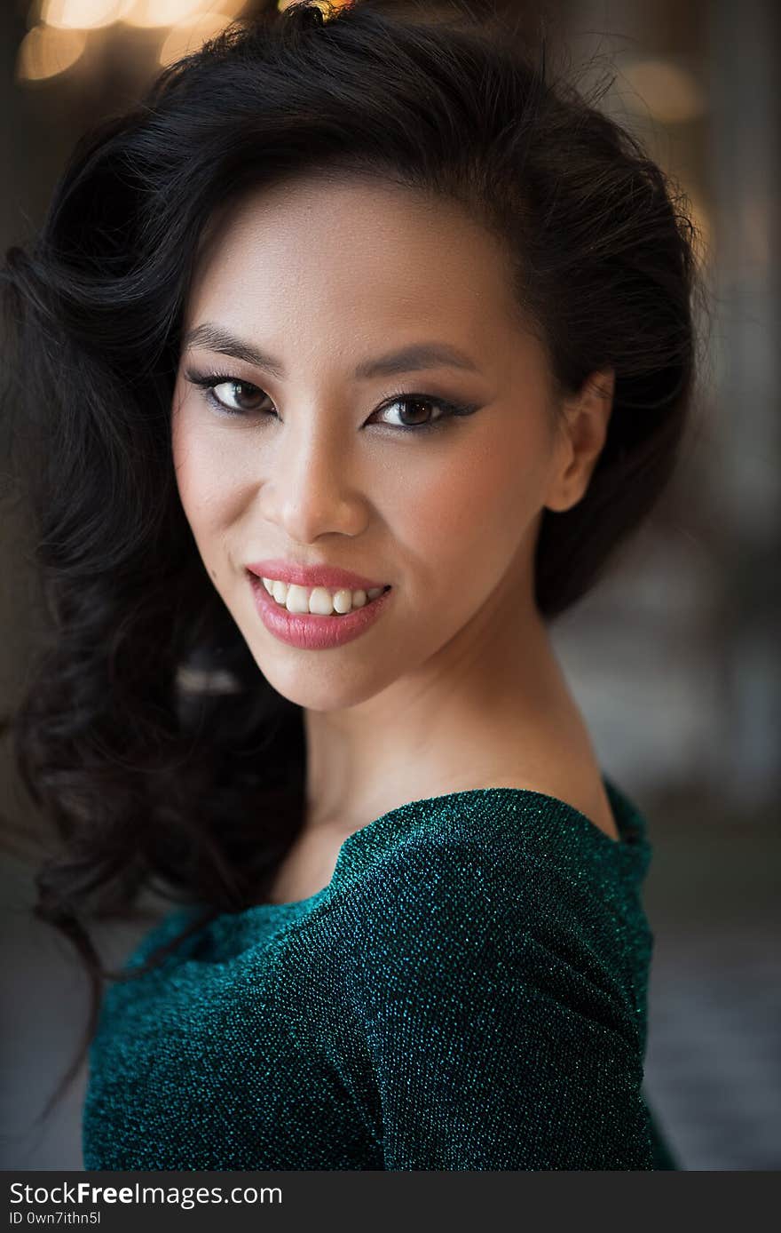 Portrait of beautiful asian woman in green dress with evening make-up