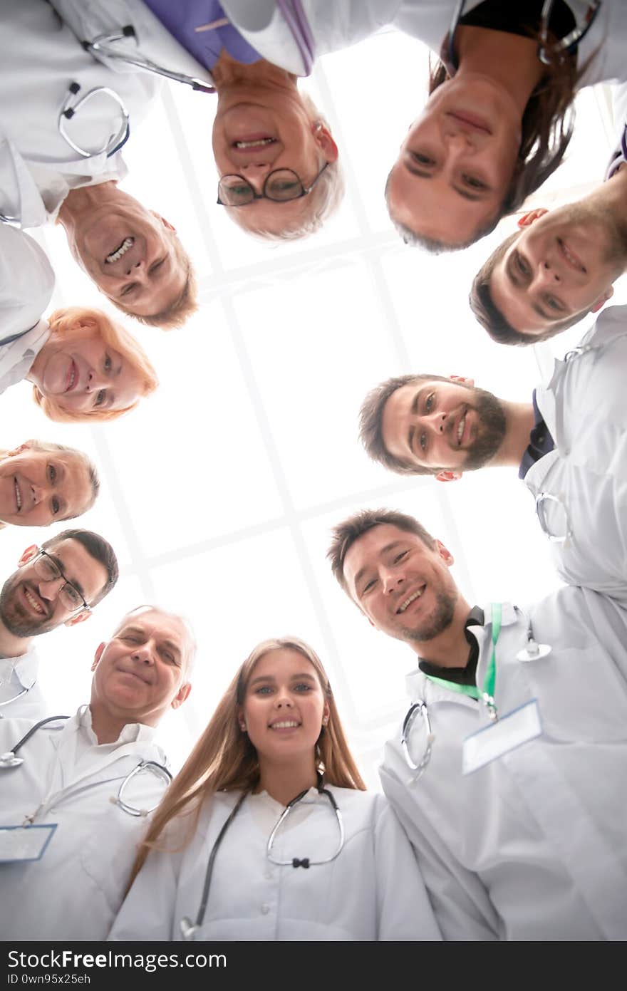 Close up. group of doctors standing in a circle and looking at you