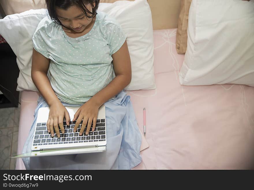 Asian children using laptop to learning and doing homework