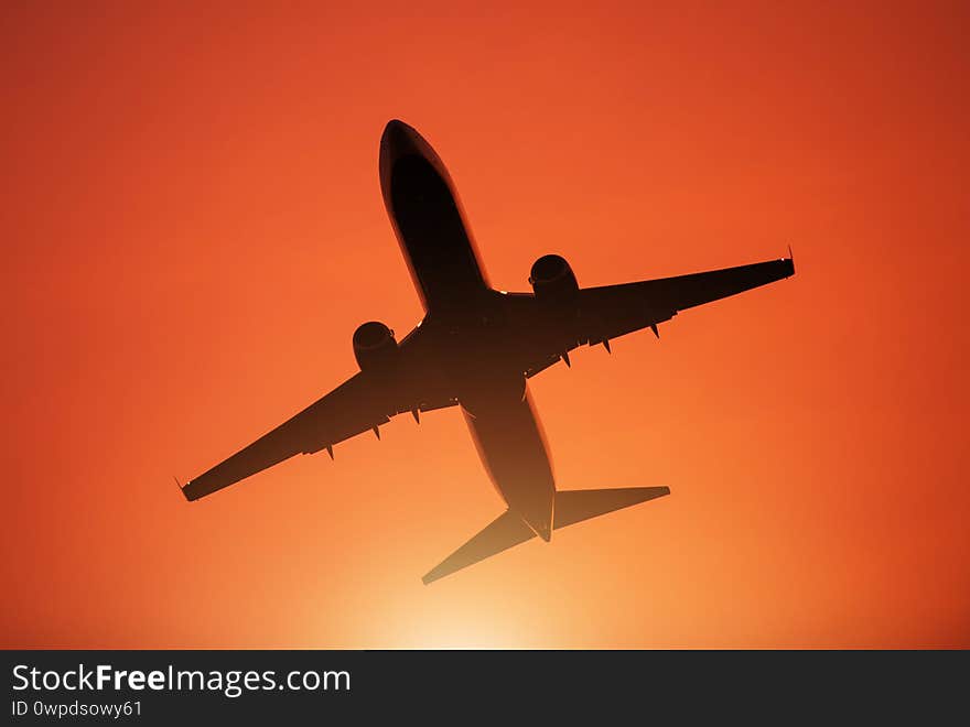 Air Travel Theme. Passenger Commercial Airplane During Take Off From Local Airport. Reddish Sunset Sky