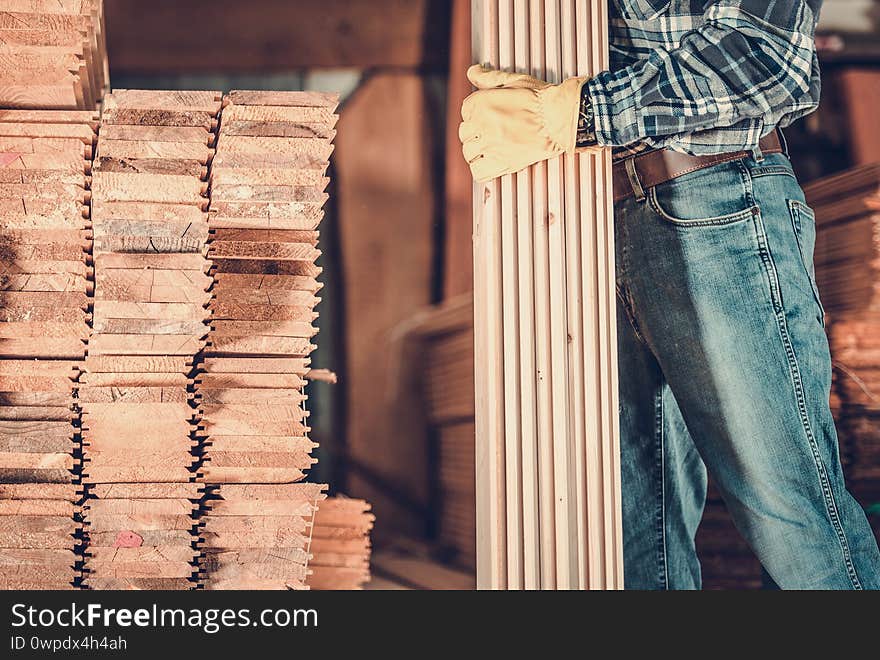 Contractor Worker With Wood Planks In Hand For Construction Project