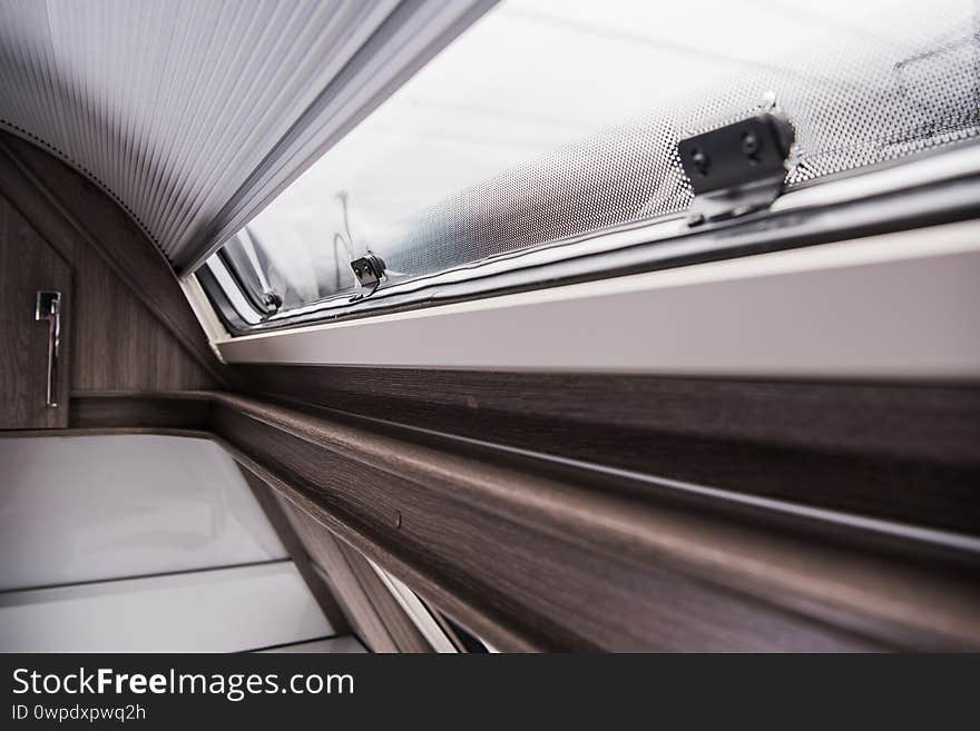 Modern Recreational Vehicle Camper Van or Travel Trailer Rounded Window and Shades Close Up. Modern Recreational Vehicle Camper Van or Travel Trailer Rounded Window and Shades Close Up