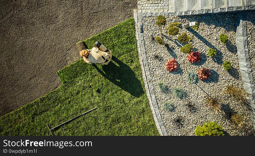 Aerial View Of Gardener Installing Brand New Grass