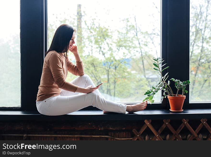 Woman relaxing at home with smart phone indoor