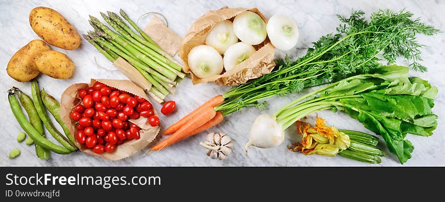 Assortment of fresh vegetables on white marble background. Top view