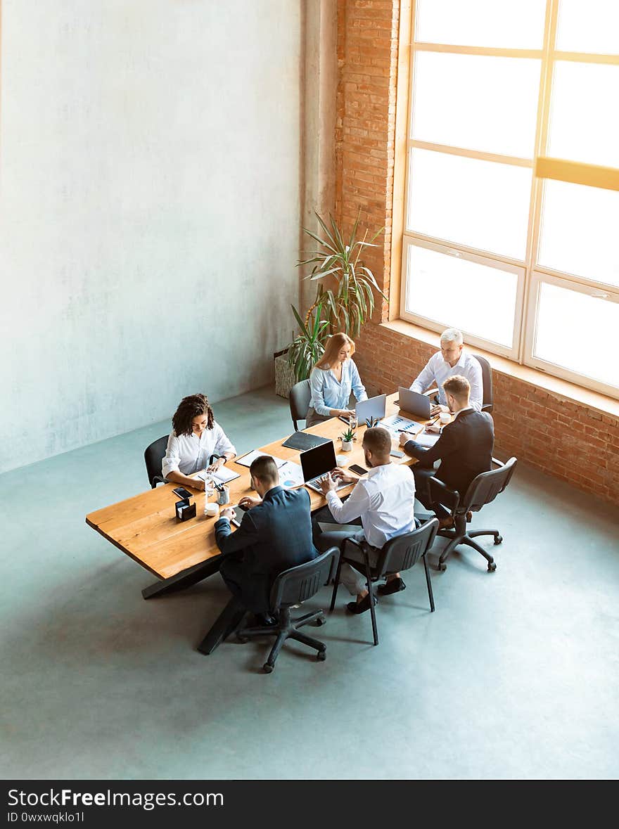 Team Of Coworkers Working Together In Modern Office, High-Angle Shot