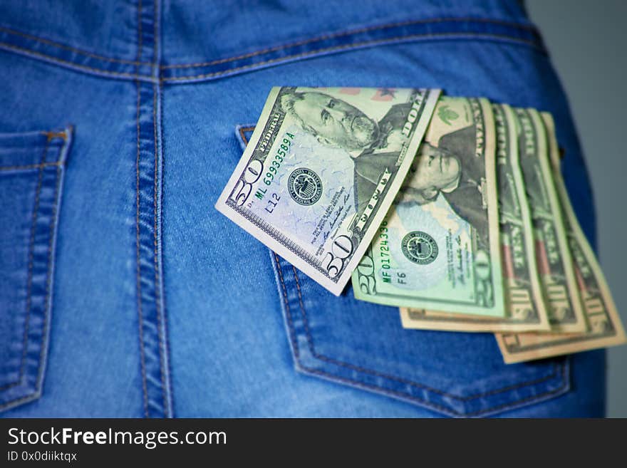 Bunch of dollars in a female jeans pants pocket. American dollar notes stuck in a woman jeans pocket. Fifty and Twenty US Dollar hanging in woman jeans. Denim and money. Dollar as the World currency . Sexy female buttock with a bunch of money in the pocket. Bunch of dollars in a female jeans pants pocket. American dollar notes stuck in a woman jeans pocket. Fifty and Twenty US Dollar hanging in woman jeans. Denim and money. Dollar as the World currency . Sexy female buttock with a bunch of money in the pocket