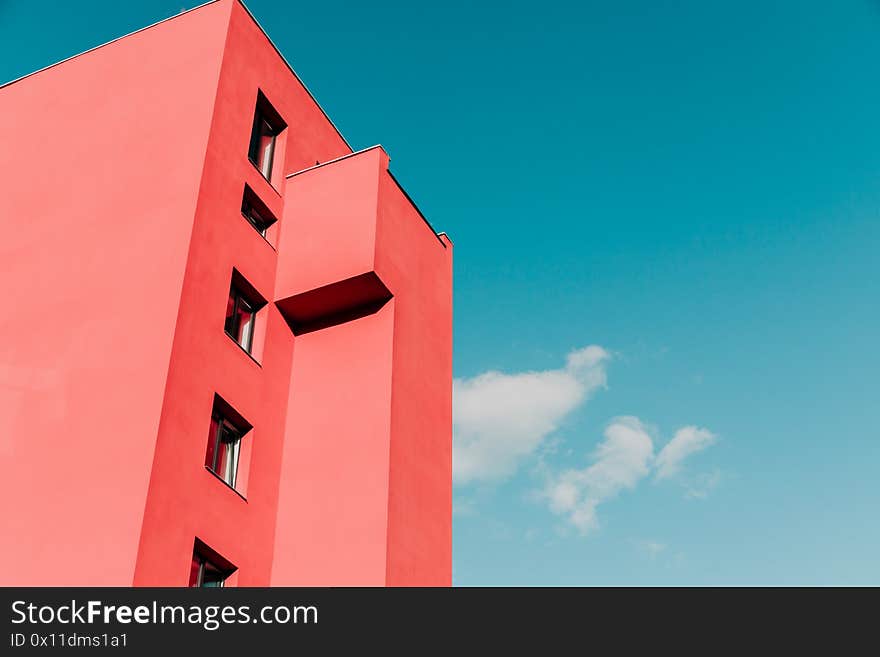 View from below on a pink modern house and sky.