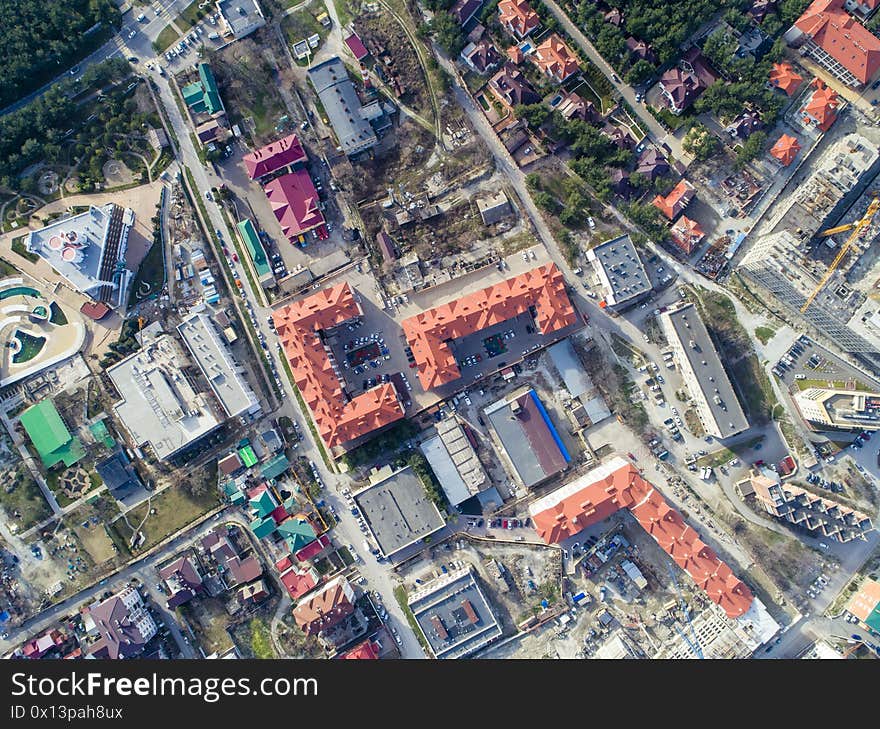 Residential complex of three multi-storey buildings with red roofs. The view from the top.