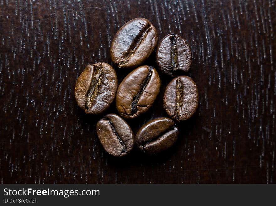 Roasted Coffee Beans On A Wooden Table