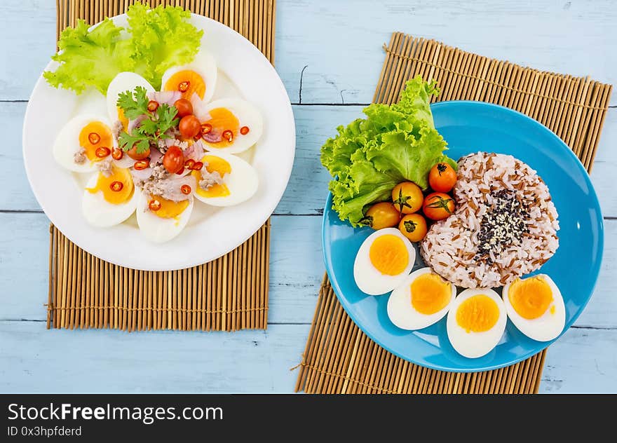 Boiled eggs with rice on blue plate