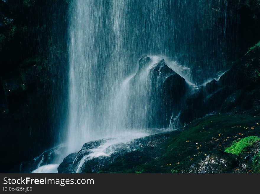 blue water beautiful waterfall in green forest and stone in jungle consist of water on background