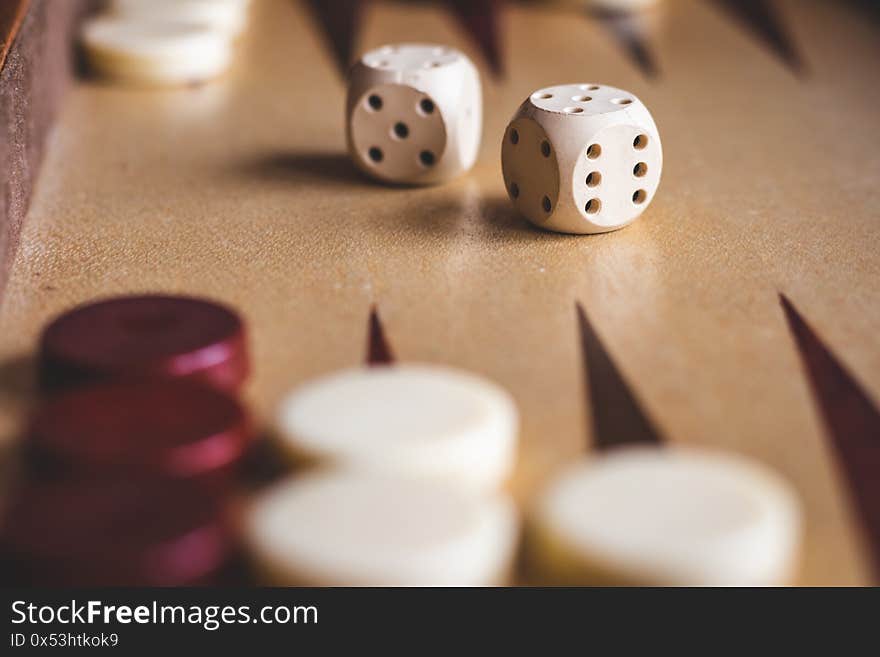 Dice on board game, playing backgammon. Selective focus. Wooden leisure game