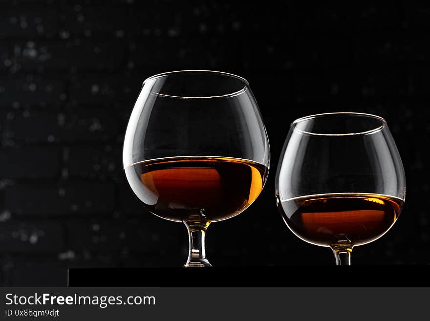 Whisky glass against dark black grunge wall