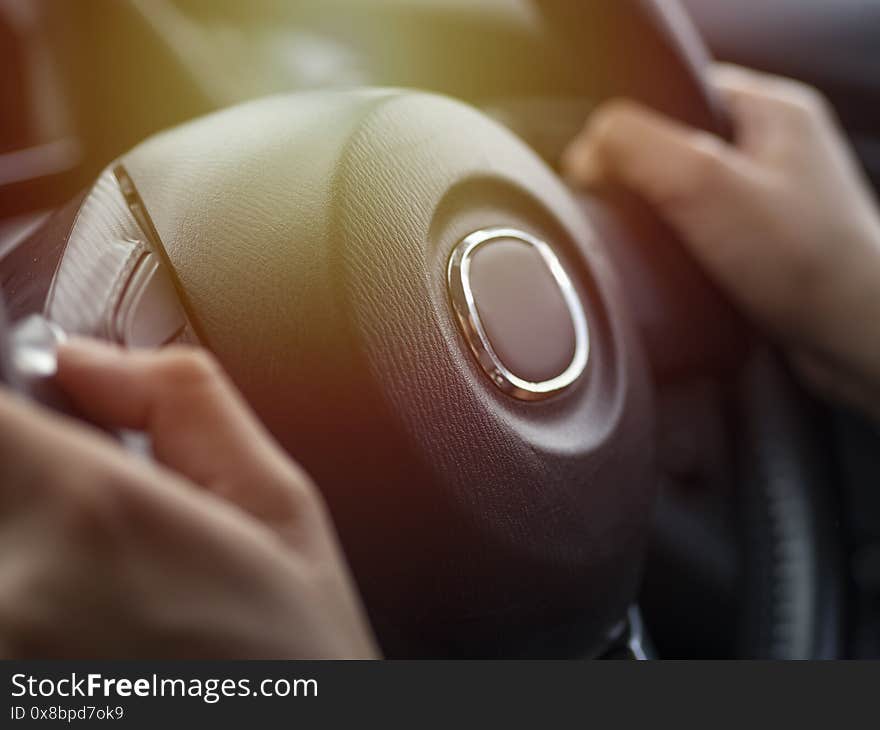 The hand is holding the steering wheel to drive the car,Because while driving, you need to concentrate and be careful.For their own safety and road users together. The hand is holding the steering wheel to drive the car,Because while driving, you need to concentrate and be careful.For their own safety and road users together