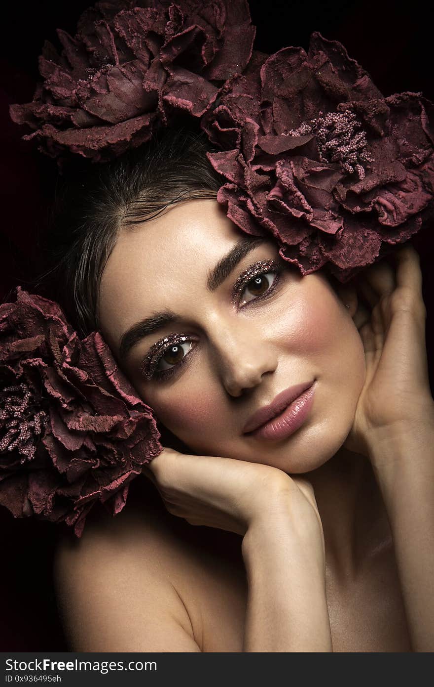 Outdoor fashion photo of beautiful young woman surrounded by flowers. Spring blossom