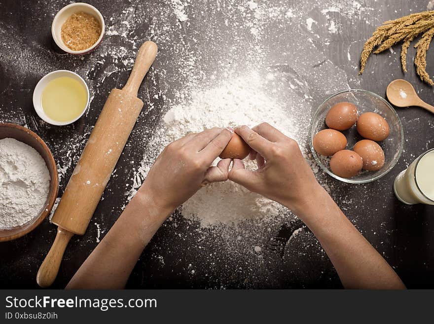 A man is baking homemade bakery over black background studio