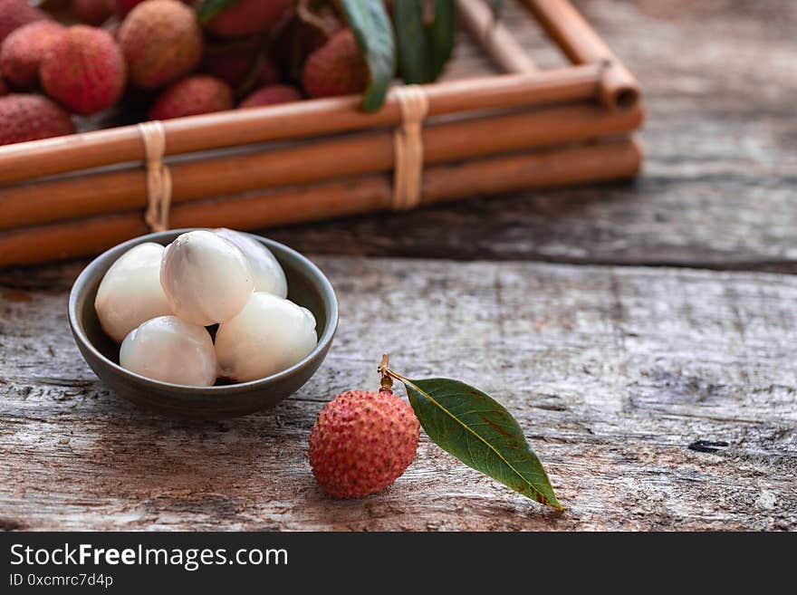 Lychee with leaves on gray background. Tropical fruit.