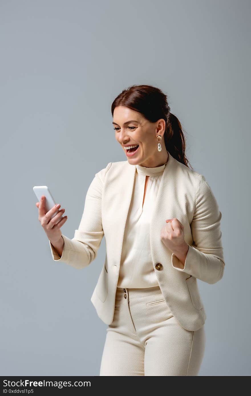 Businesswoman showing yeah gesture while holding