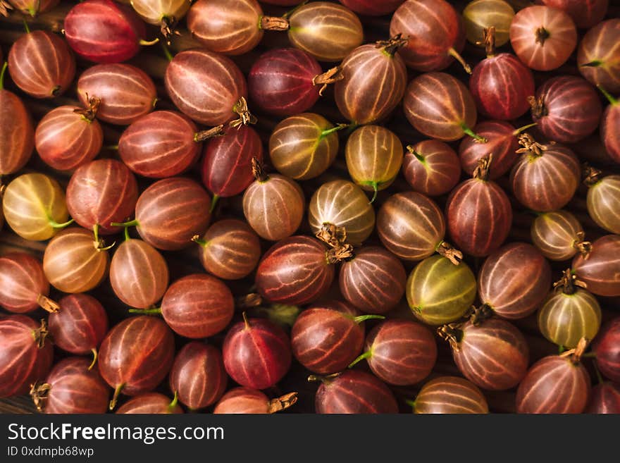 Fresh gooseberry closeup on a wooden board, healthy food. texture background