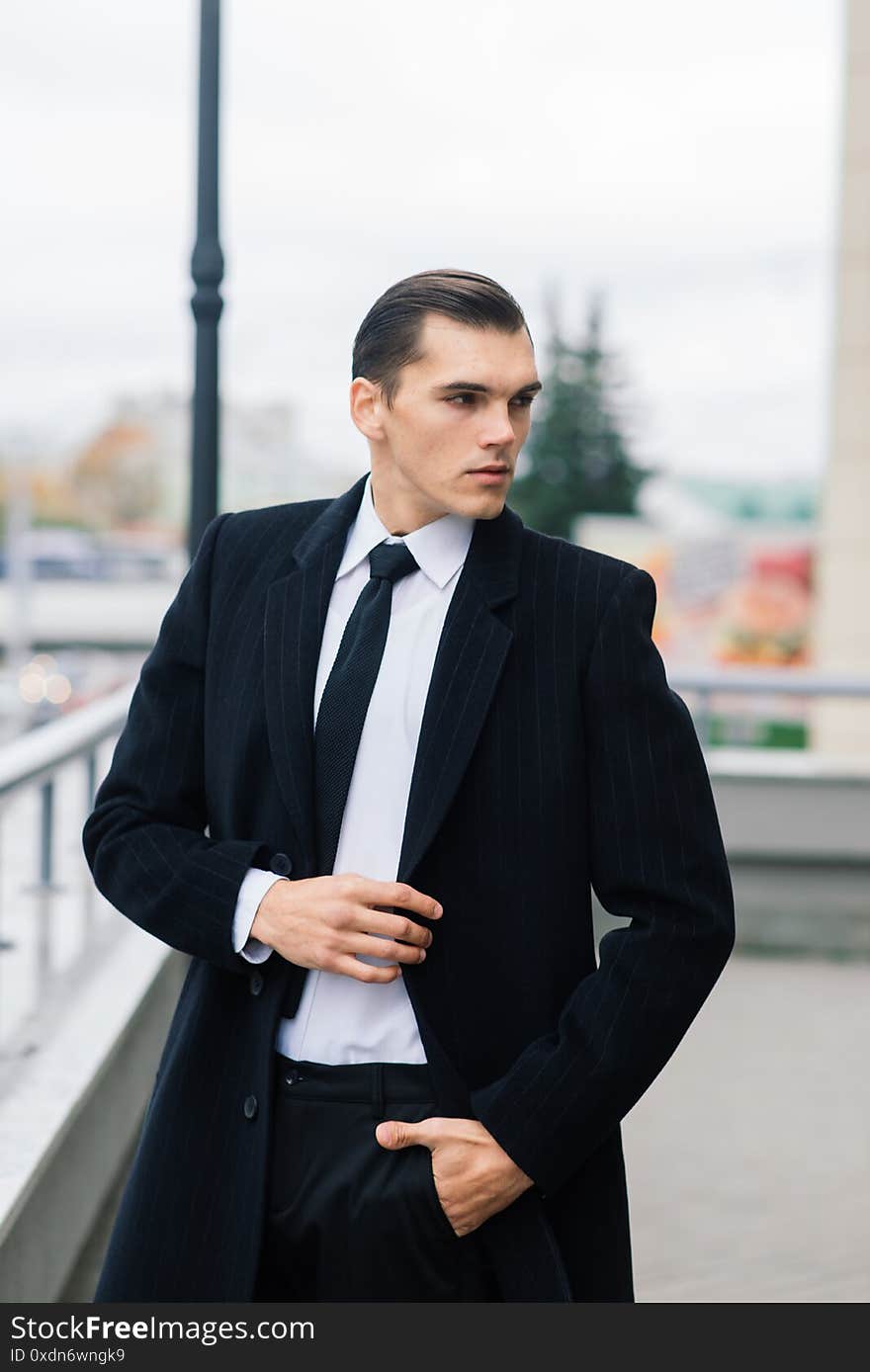 Man in a stylish suit. Businessman in an autumn city, fashion