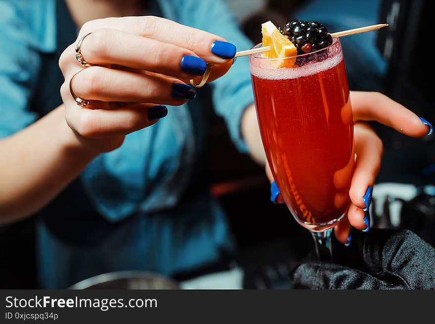 The Barman Decorates The Alcoholic Cocktail With Berry. Close-up.