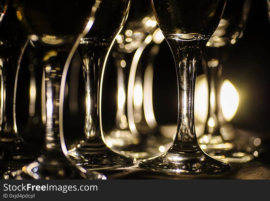 Close up photo of glasses of champagne in the dark on the table